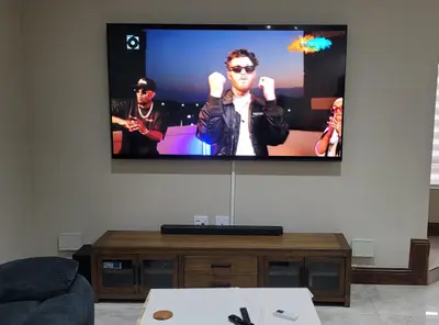 Professional TV wall mounting with soundbar entertainment setup